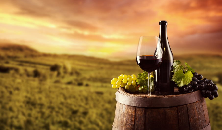 Red wine bottle and glass on wodden keg