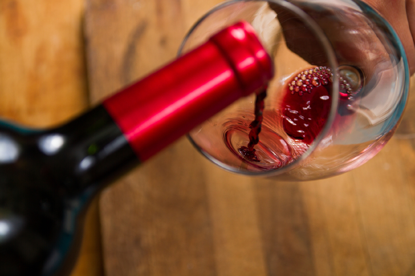pouring red wine into a glass