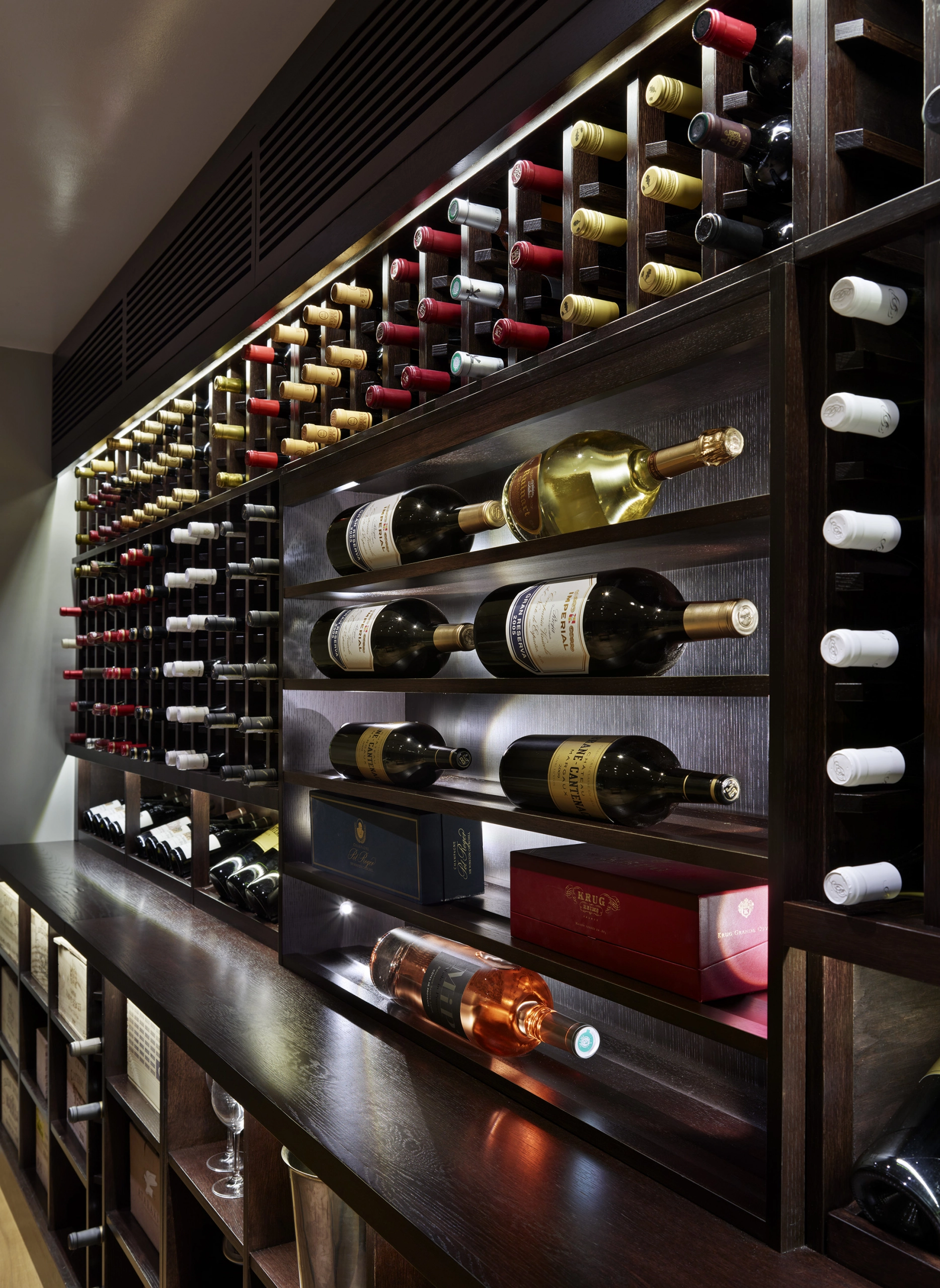 a wine wall display shown in a bar context