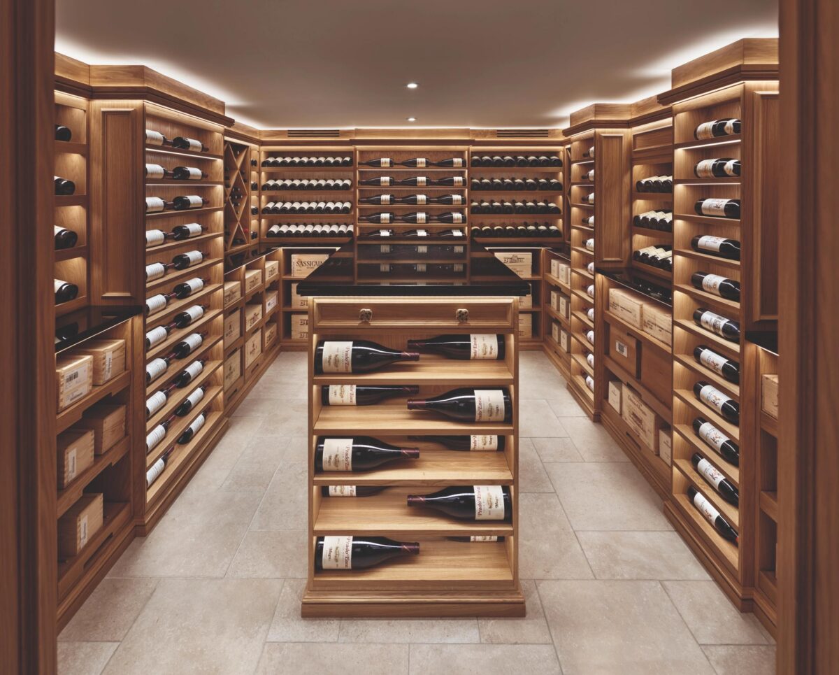 a wine room with uplights and pale wood