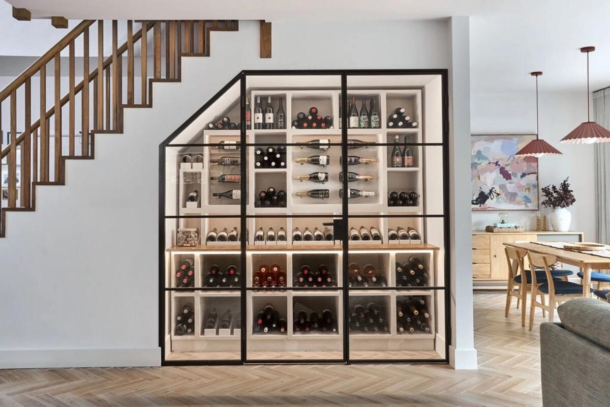 a custom wine display built to fit under a set of stairs
