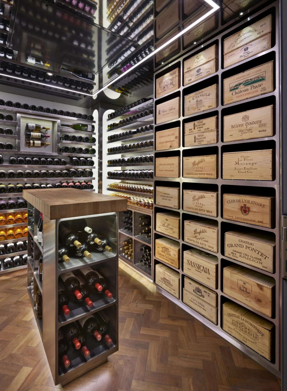 wine room with a dark wood panel floor and shelving with a mix of wine bottles and wine boxes on display